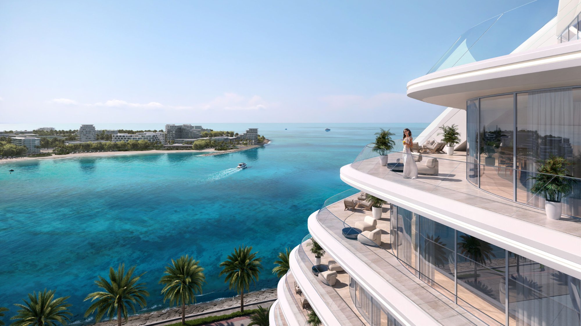 Oystra private terrace — sweeping views over the turquoise Al Marjan Island lagoon from a curved balcony with outdoor seating
